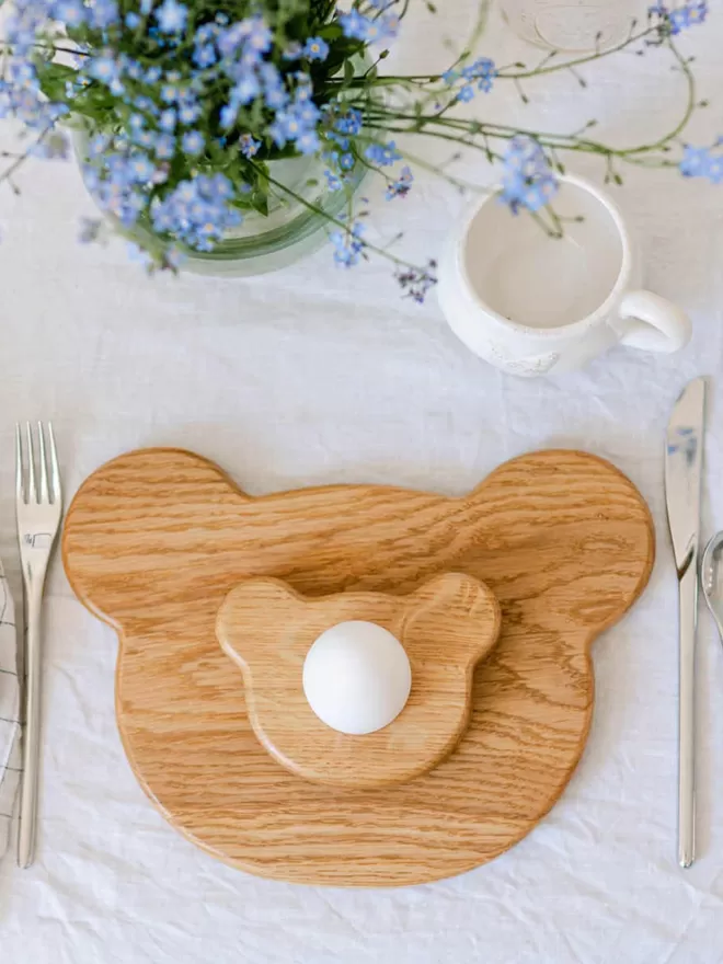 Wooden Bear Breakfast set with board and egg cup birdseye view with mug and flowers