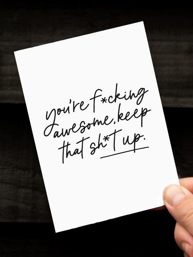 Handing holding up the Awesome Birthday Card that reads "you're f*cking awesome keep that sh*t up"