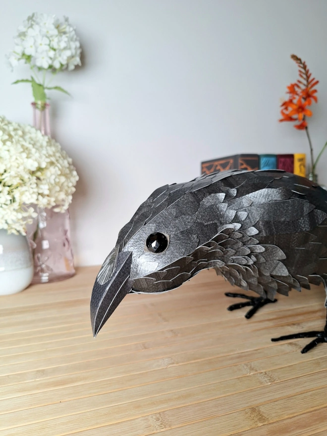 Raven sculpture made from handprinted papers