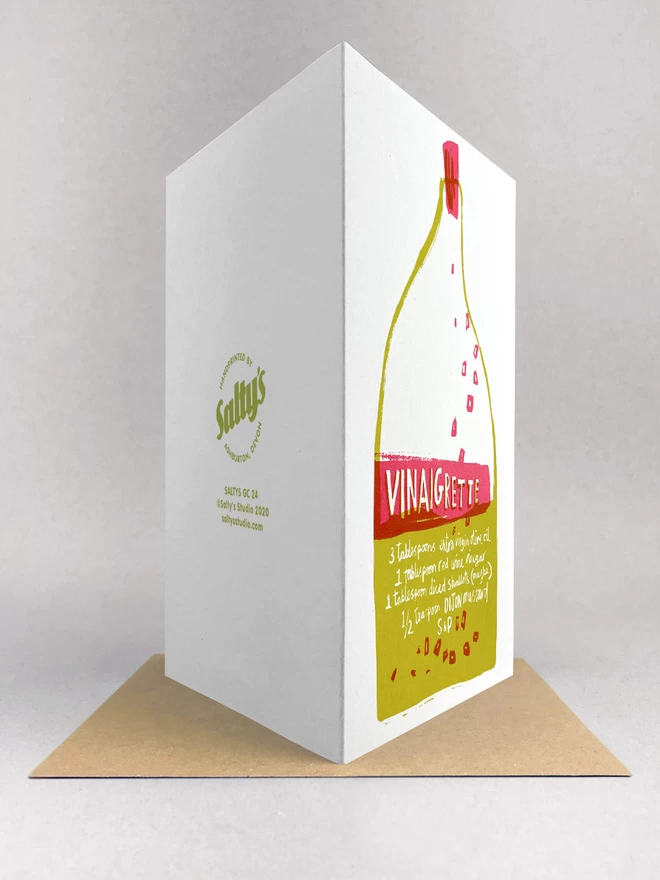 Rear view of an original design, handprinted Greetings Card featuring a bottle of  Vinaigrette dressing with the recipe written on the label, made from recycled card, by Salty's Studio.