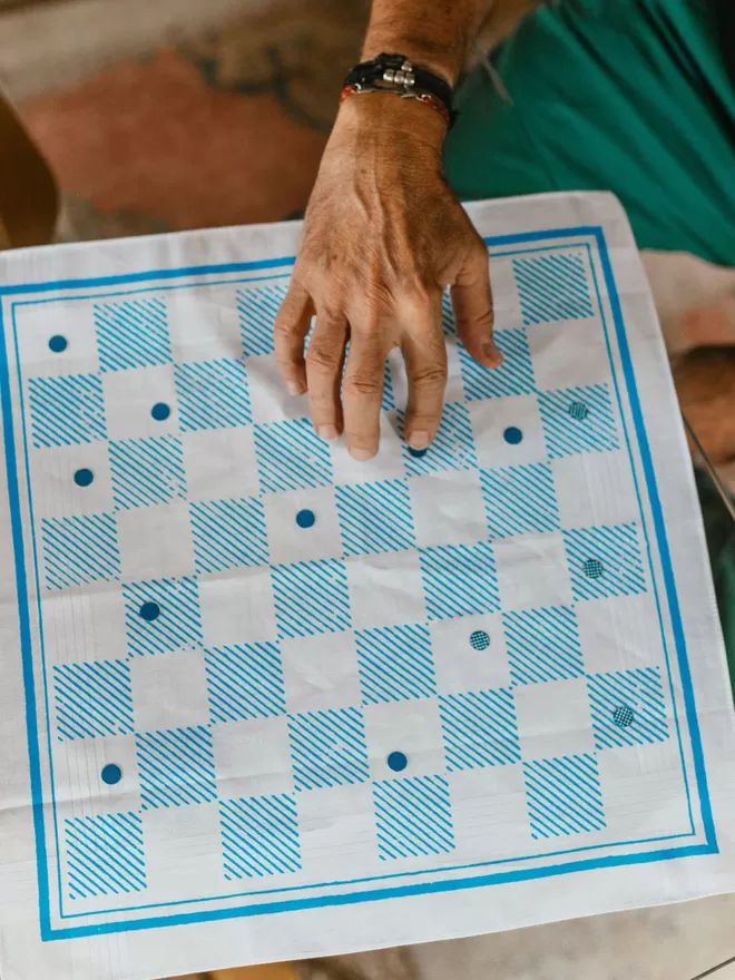 A Mr.PS Checkerboard game handkerchief being played with family