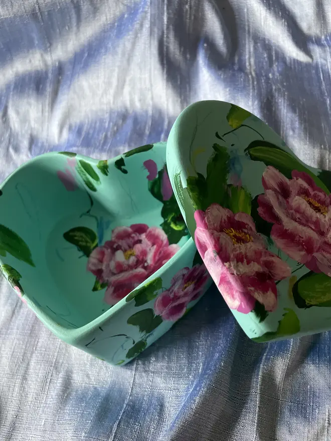 hand painted floral ceramic heart shaped keepsake box background in a pale blue with pink peony flowers