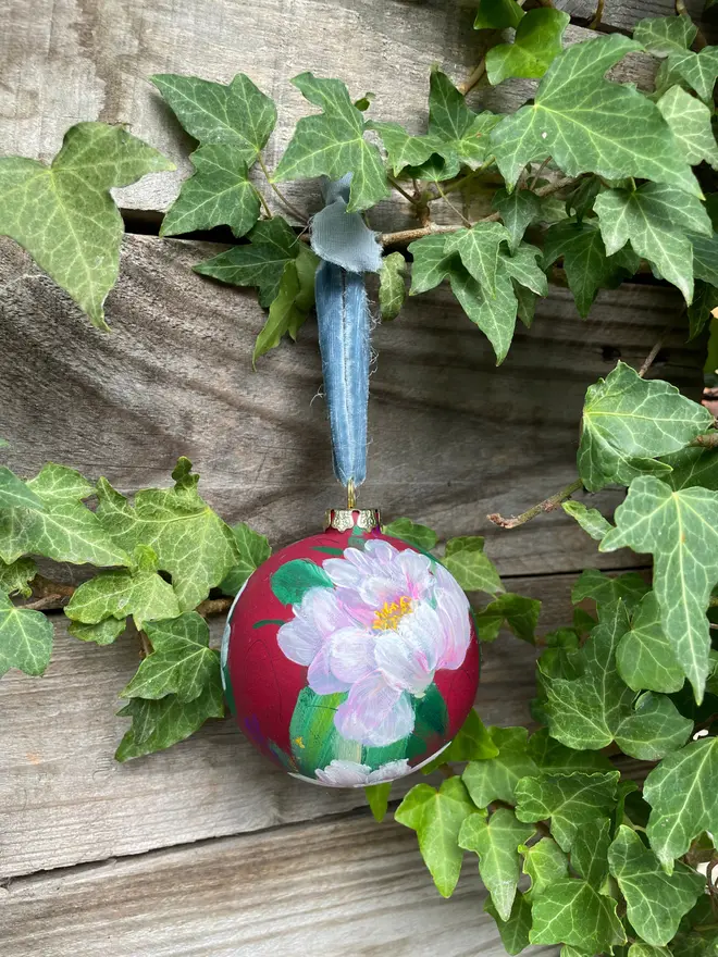 xHand painted floral bauble maroon background adorned in delicate pink peony flowers