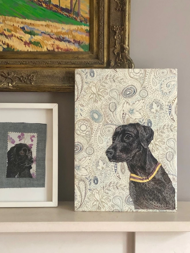 embroidered pet portrait of a black lab on a mantlepiece
