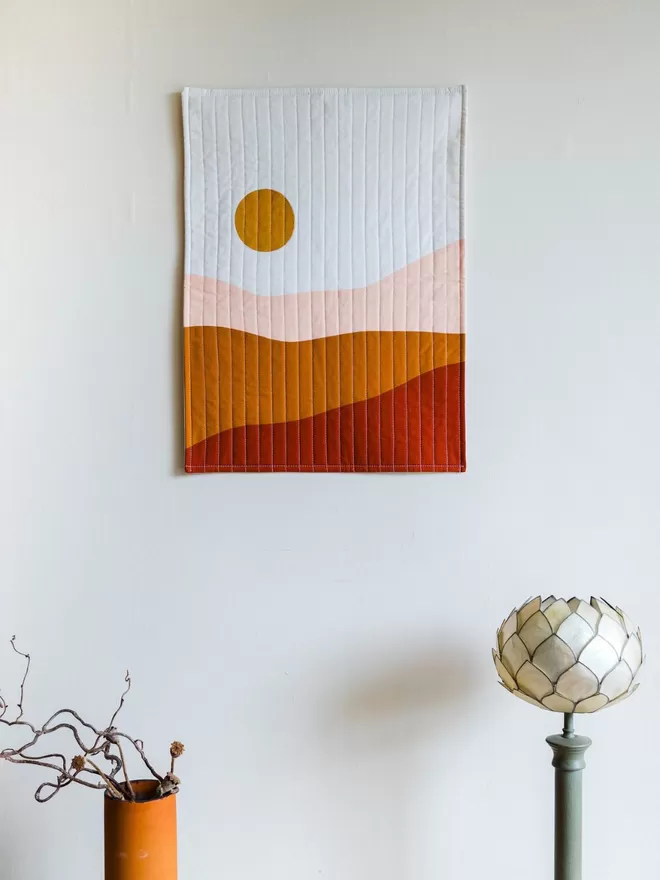 Earth Quilt Hanging on White Wall