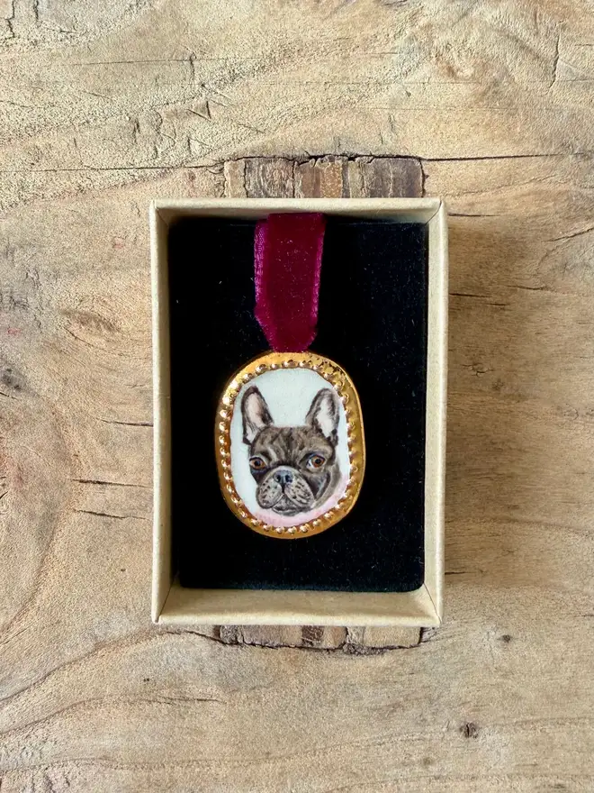 custom pet portrait pendant miniatures. a miniature painted dog portrait in a pendant frame.