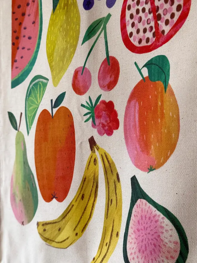 Fruit Print Fabric Banner, hanging on a green wall. 