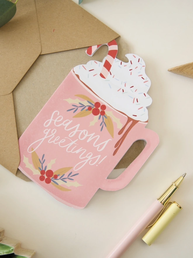 Seasons greetings illustrated pink cutout hot chocolate Christmas card