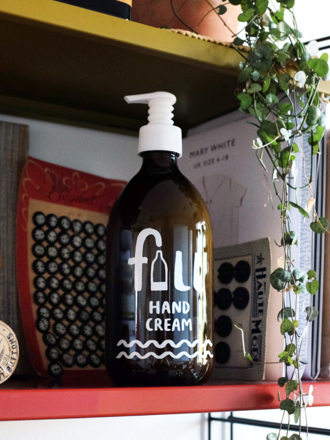 Hand Cream. An amber glass jar with a lotion pump.