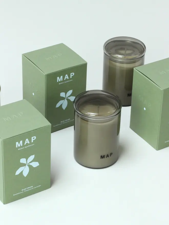 blue fields lavender and sandalwood candle. candle photographed next to plastic free packaging boxes.
