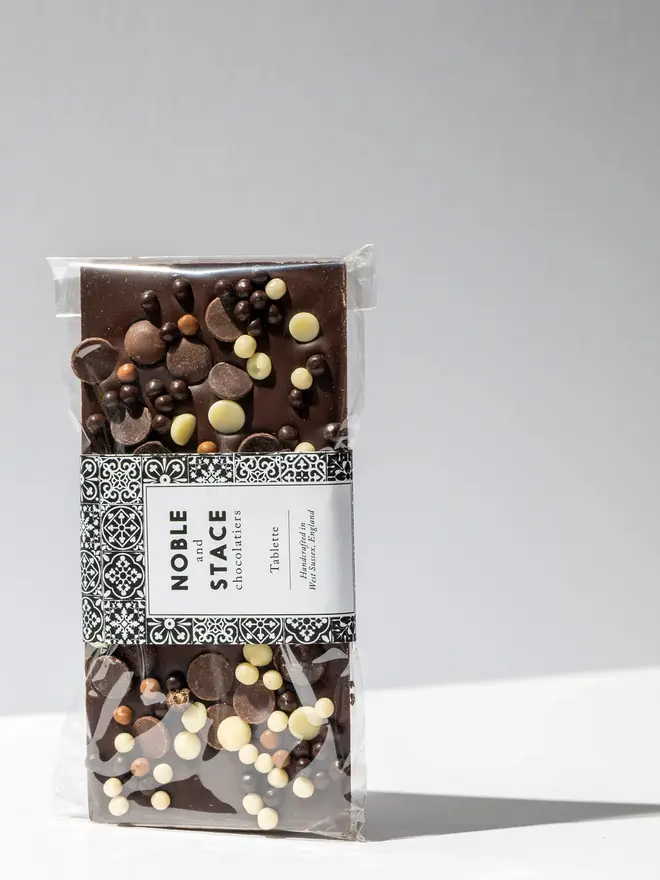 Loaded chocolate tablette standing on a white table. 