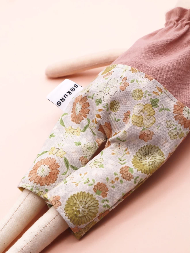 Pastel coloured floral print trousers for doll.