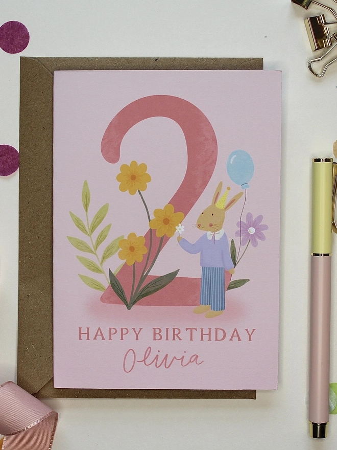 personalised floral 2nd birthday card. pink 2nd birthday card with illustrated rabbit and flowers.
