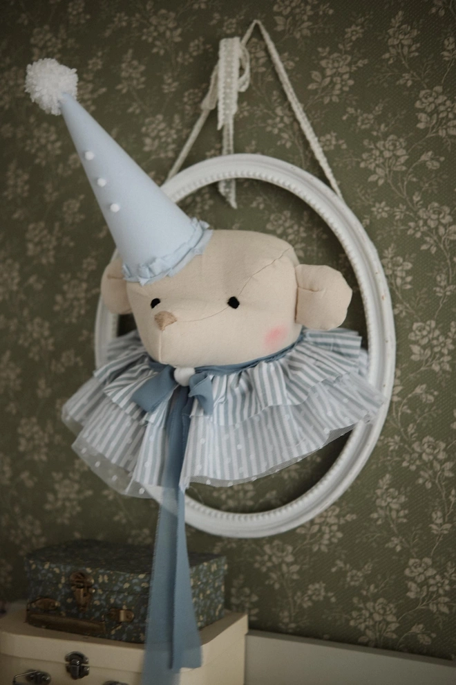 Bear Head Nursery Decoration, a bear decoration sitting against a wall in a child's decorated bedroom. 