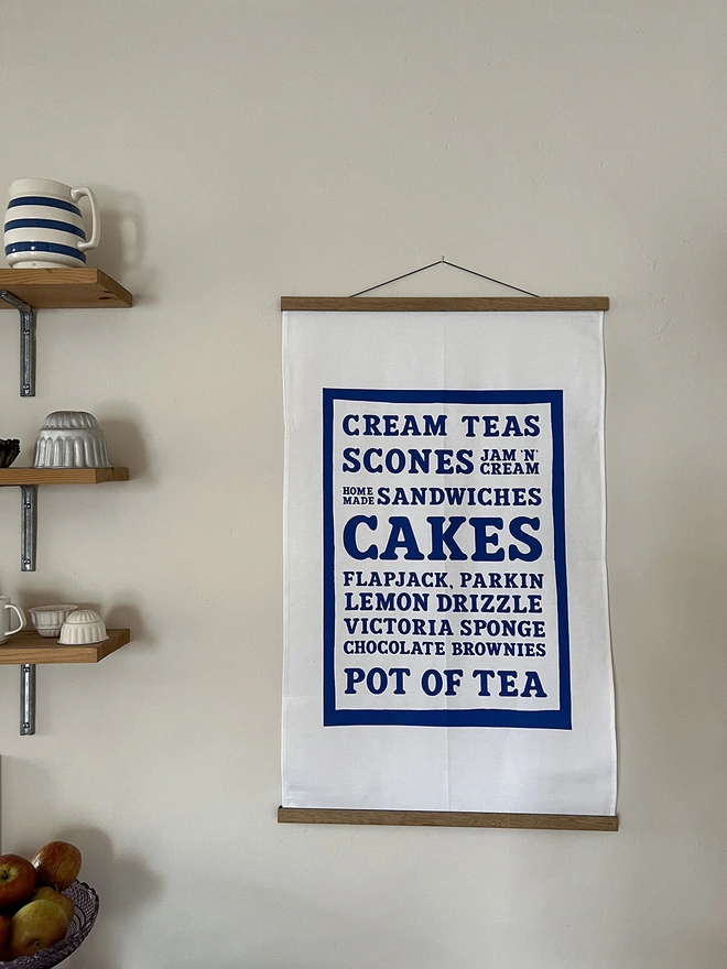 Mr.PS Cakes Cream Tea Menu tea towel displayed using the optional hanger