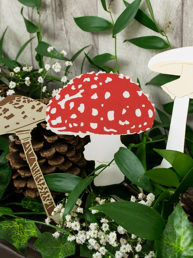 Mushroom Decorations displayed in greenery on mantelpiece