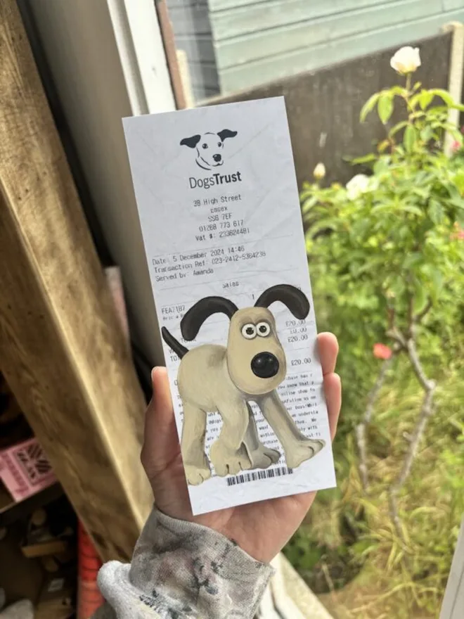 Gromit Dog Trust Receipt Print, against a green background. 