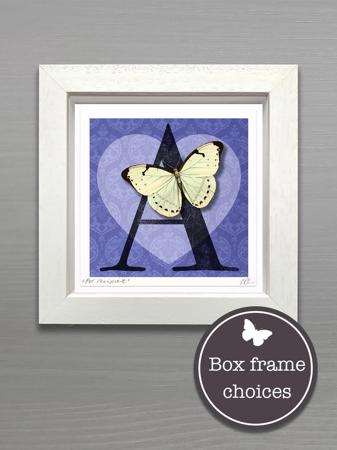 A hand made initial Valentine’s Day card featuring a heart, the recipients initial and a white paper cut three dimensional butterfly sits on the heart. The hand made card is in a white wooden frame showing the gift option of this keepsake card.