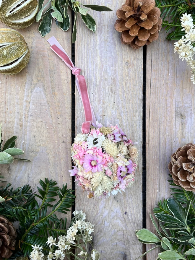 Pink Bauble. A bauble made of dried flowers in pinks and whites.