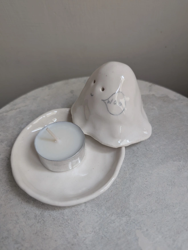 white ceramic tealight candle holder in the shape of a wee ghostie ghost  