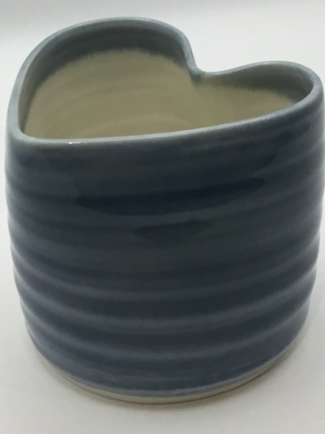  a tea light holder glazed in blue on the outside and white on the inside.
