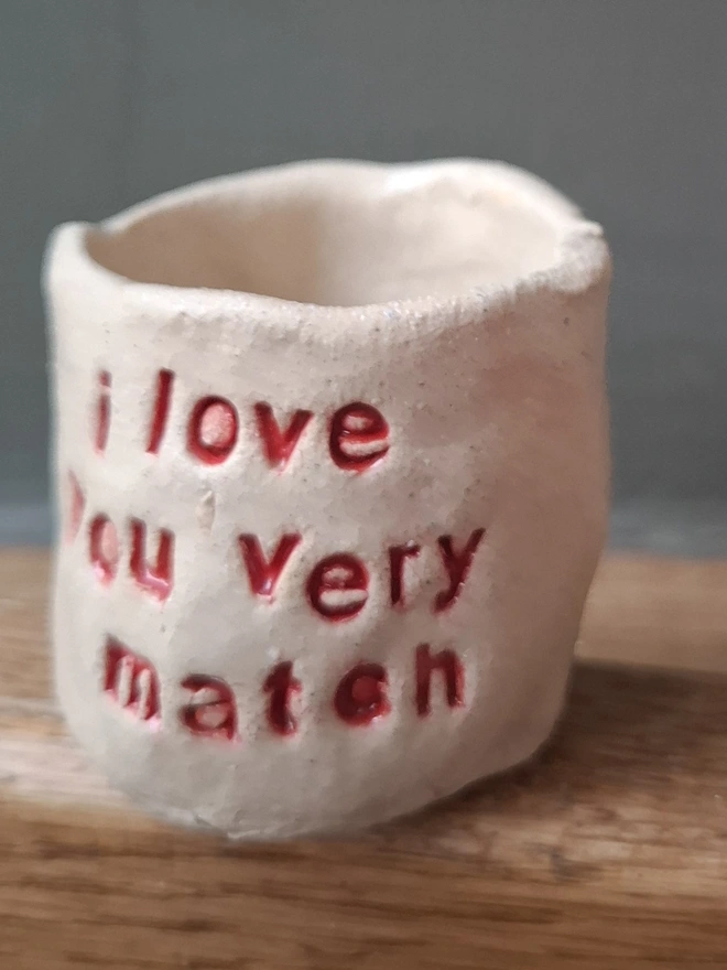 Short Ceramic Match Holder with the phrase 'I love you very match' stamped into it 