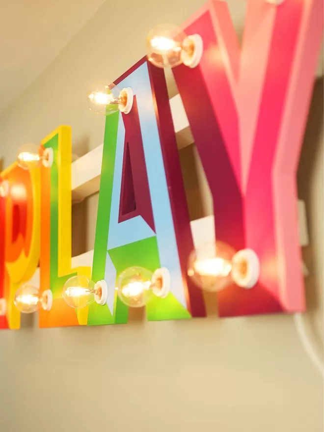 Play sign with lights seen in a kids room