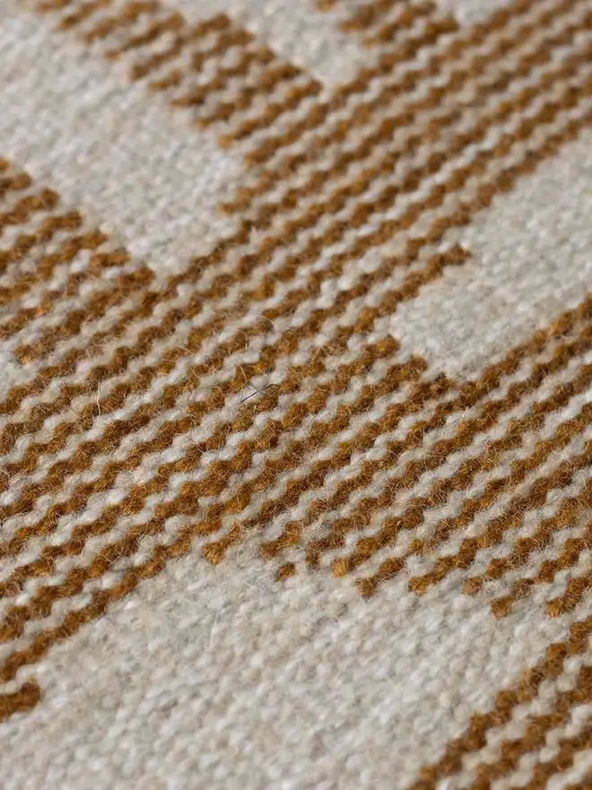 Tudor Flatweave Rug, a colourful rug in a living room. 