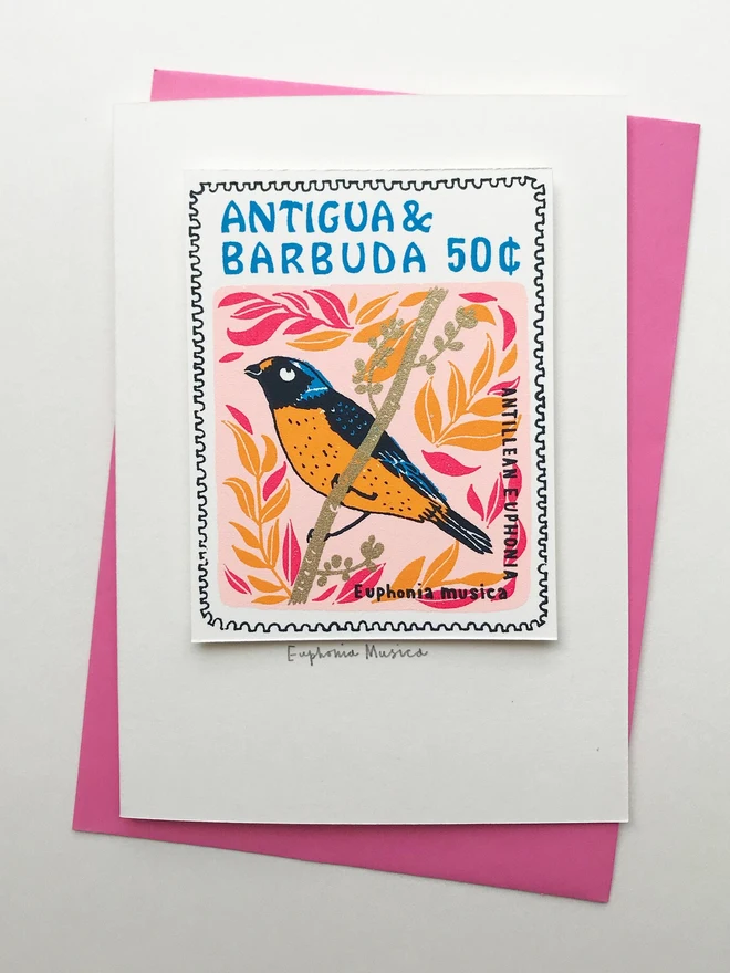Bird Stamp Card Euphonia Musica Bird/Antigua & Barbuda, a white card with a colourful bird design on top of a purple envelope on a white background. 