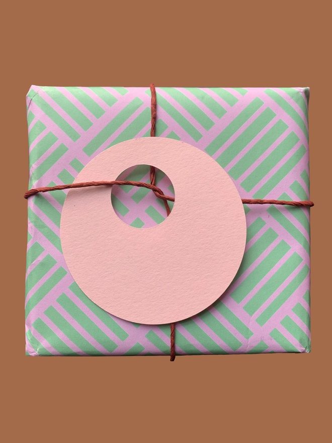 Geometric Criss Cross pink and green paper with pink circle gift tag