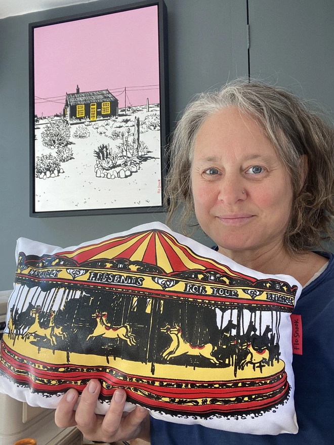 Artist holding handmade carousel cushion