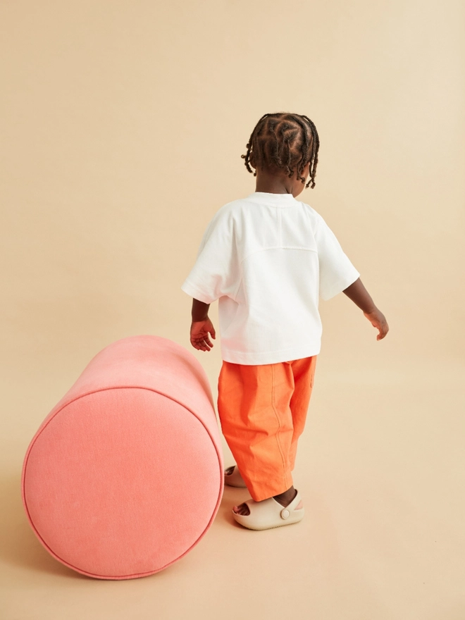 oversized rounded bright orange kids trousers modelled by a toddler