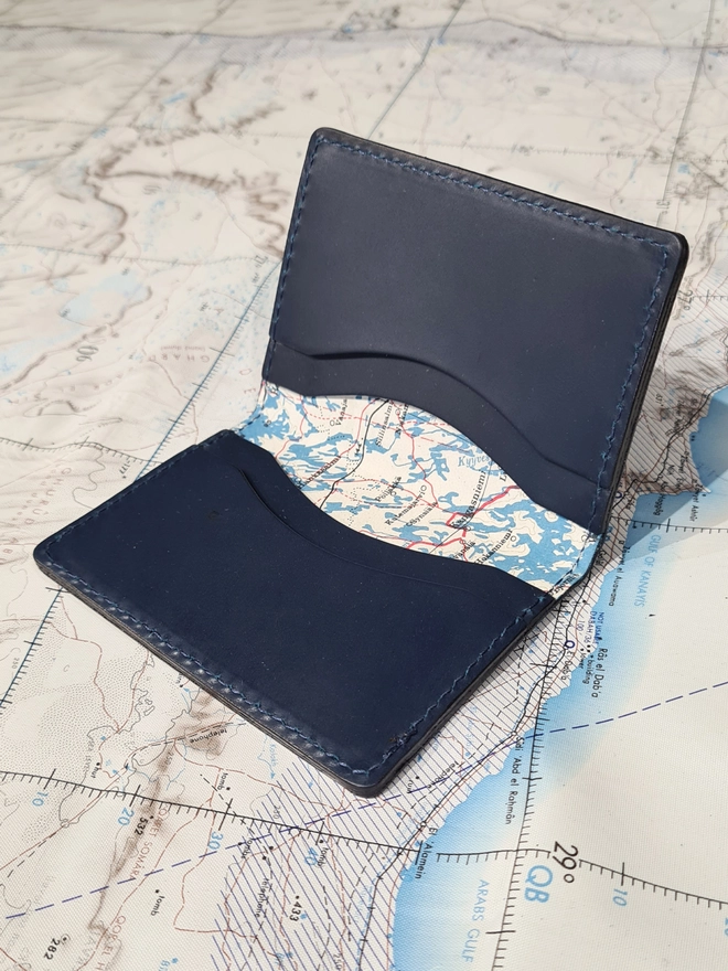 natthakur blue leather card holder opened to show a rare original silk escape map from the Cold War