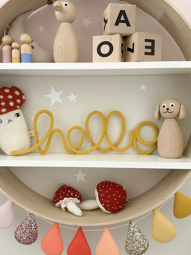 hello knitted wire word sign by hey kiddo studio - kids nursery decoration on a shelf with other small business products