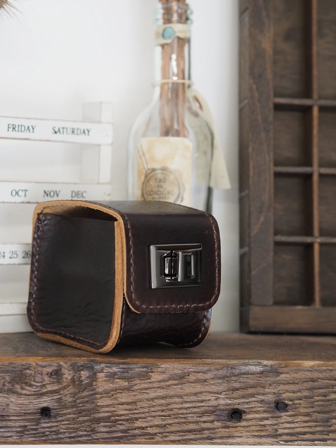 Handmade leather watch case. A dark brown leather watch case with gunmetal grey coloured turn lock