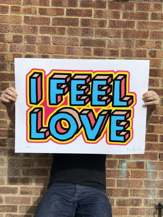 "I Feel Love" Hand Pulled Screen Print  white background with large letters that say “I Feel Love’ with pink and yellow outline and hand drawn letters 