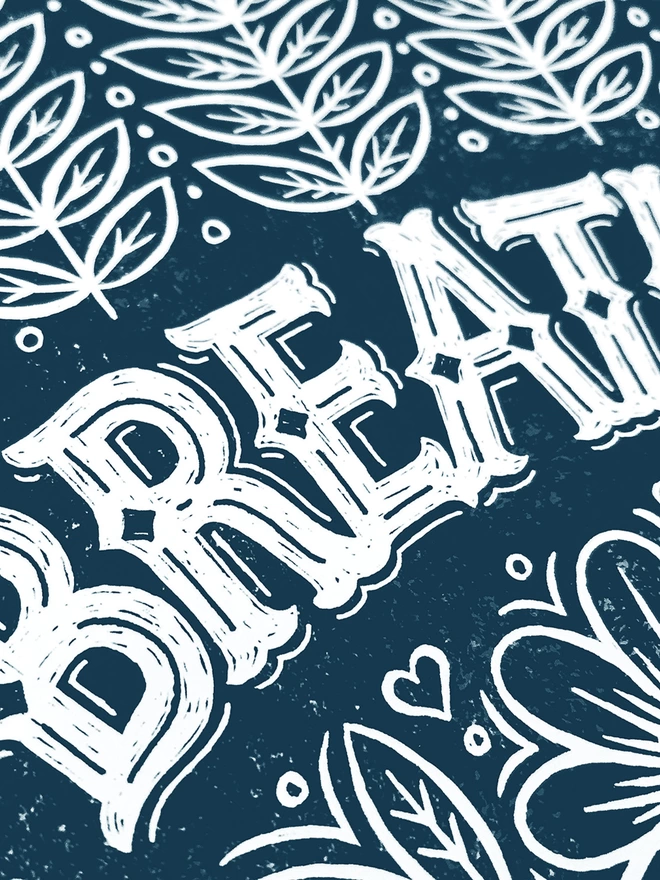 detail of white lettering on blue hand yoga breathe print