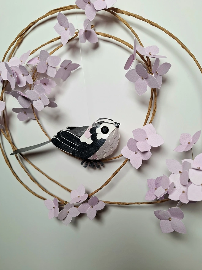 little bird sculpture made from hand printed papers