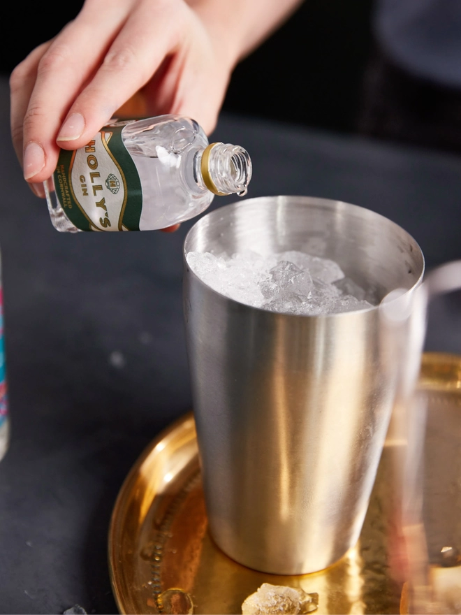 Pouring Holly's Gin from miniature into a cocktail shaker