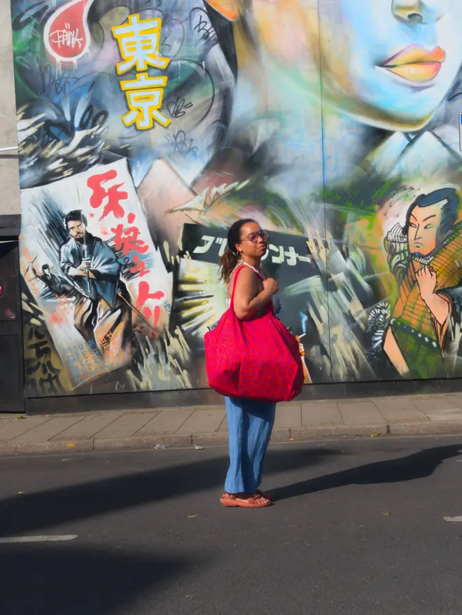 nakita holding red leopard bag