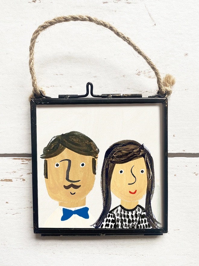 hand painted picture of man and lady in a frame