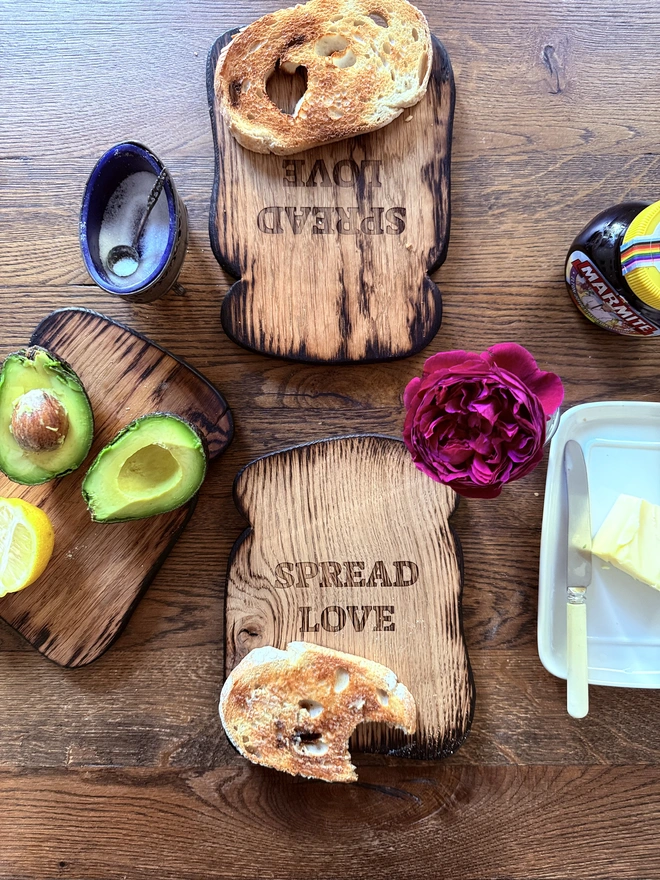 Small toast serving board with engraved spread love message 
In breakfast setting.