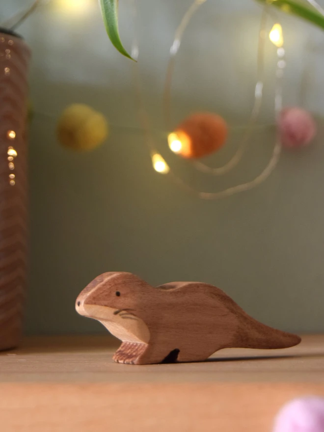 wooden toy otter cub in shelf