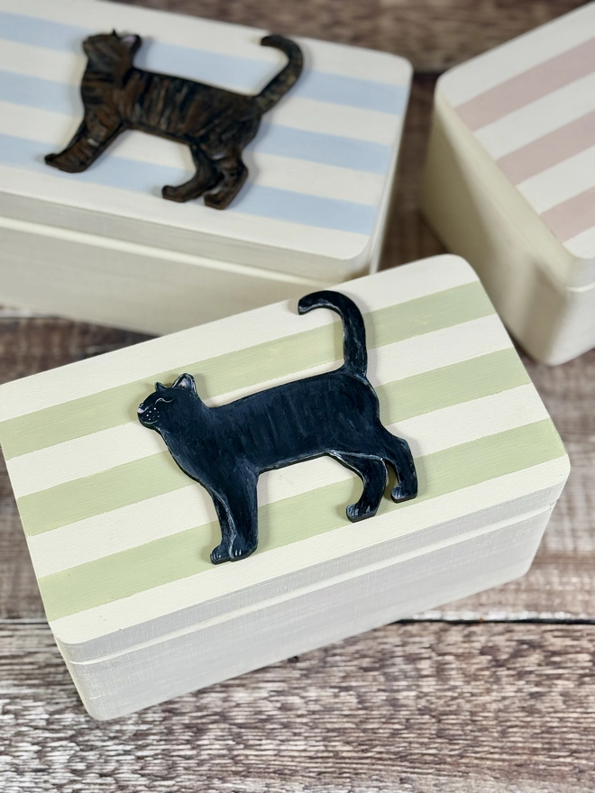 sage green and cream striped small wooden keepsake box with a hand - painted wooden black cat 