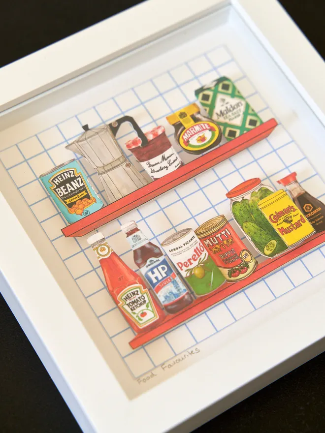 3D paper collage showing favourite cupboard staples on a shelve framed