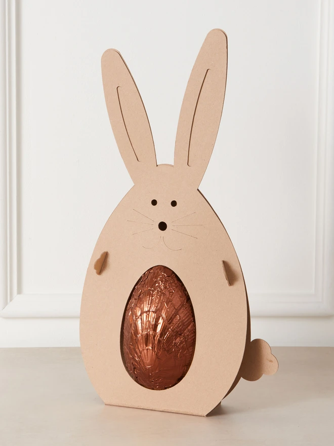 affogato coffee chocolate easter egg. a coffee chocolate easter egg photographed in bronze foil in a cardboard rabbit