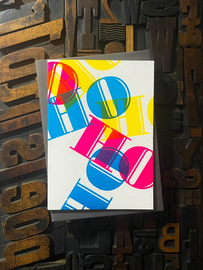 Ho Ho Ho! A beautiful typographic letterpress Christmas card. Printed with rich vibrant and fluorescent blue, magenta and yellow inks with luxury matching and contrasting envelopes; ideal to send to your designer friends at the festive season.