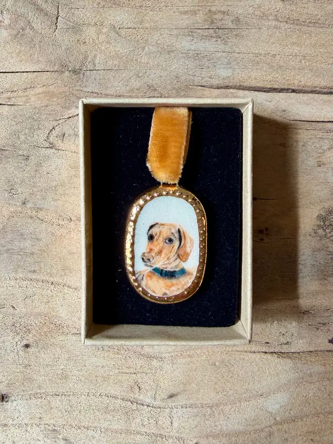 custom pet portrait pendant miniatures. a miniature painted dog portrait in a pendant frame.