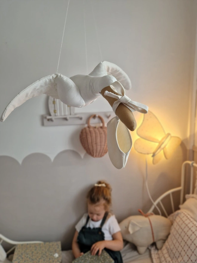 Flying Stork Hanging Decoration, a hanging stork decoration suspended in a child's bedroom. 