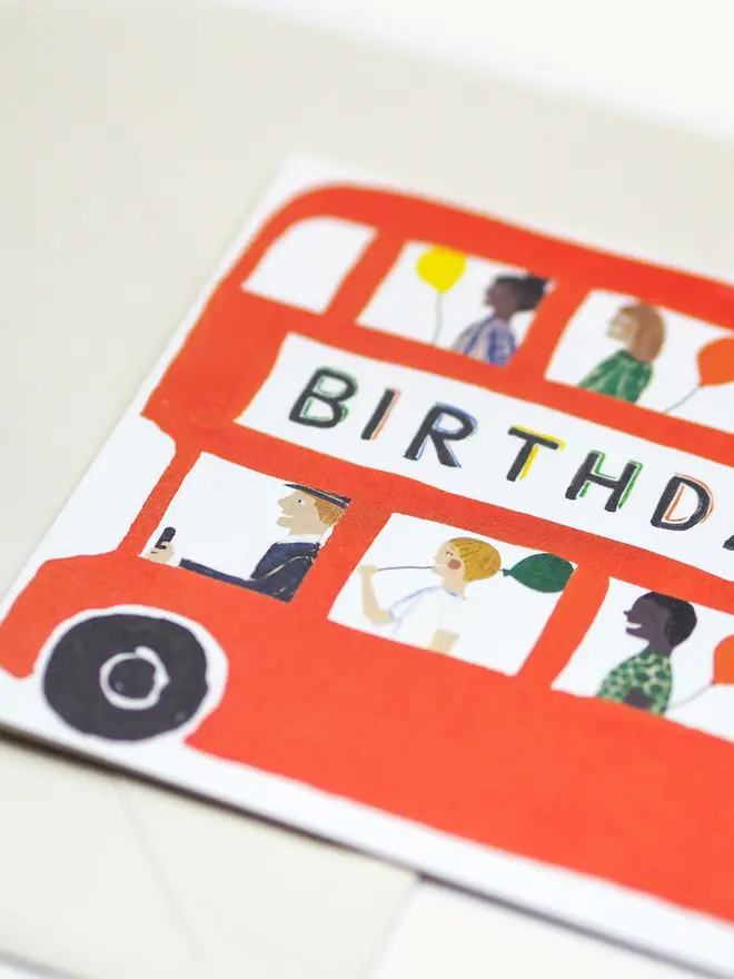 bright red bus card with birthday design and imagery